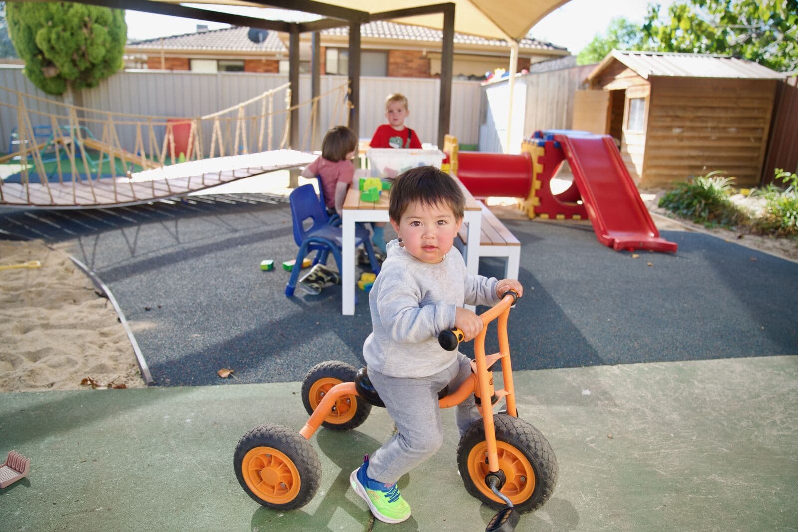A child riding a tricycle in the outdoor play space at Guthrie Street Child Care Shepparton